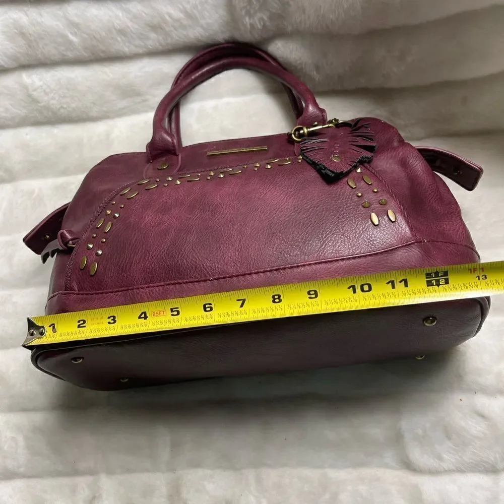 Steve Madden burgundy faux leather satchel with rustic studs accent.
